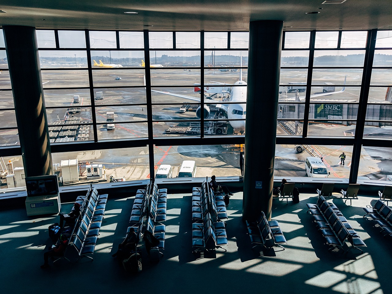 A view of an airport runway from inside the terminal.
