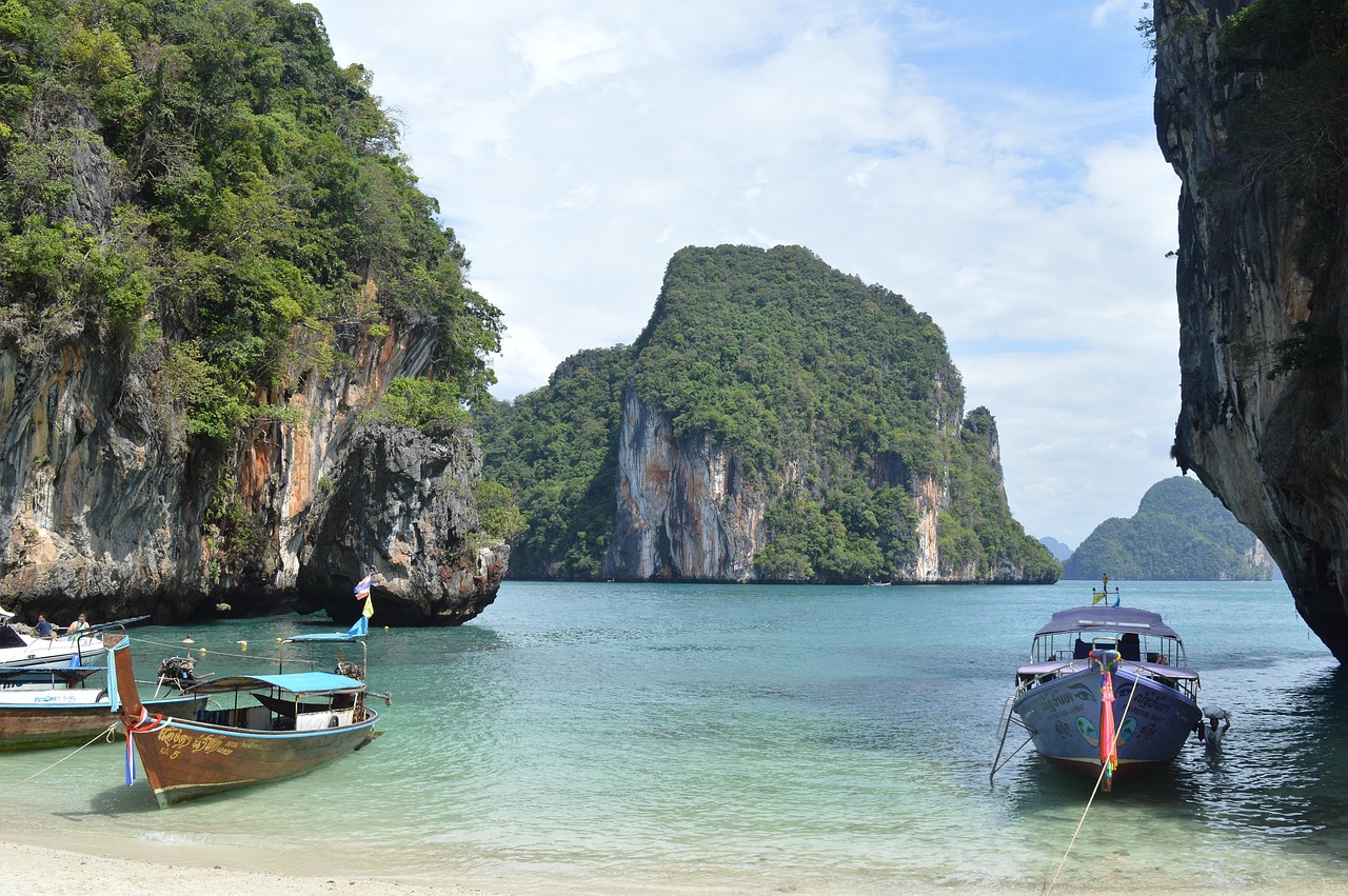 A view from the beach, looking at boats on the water.