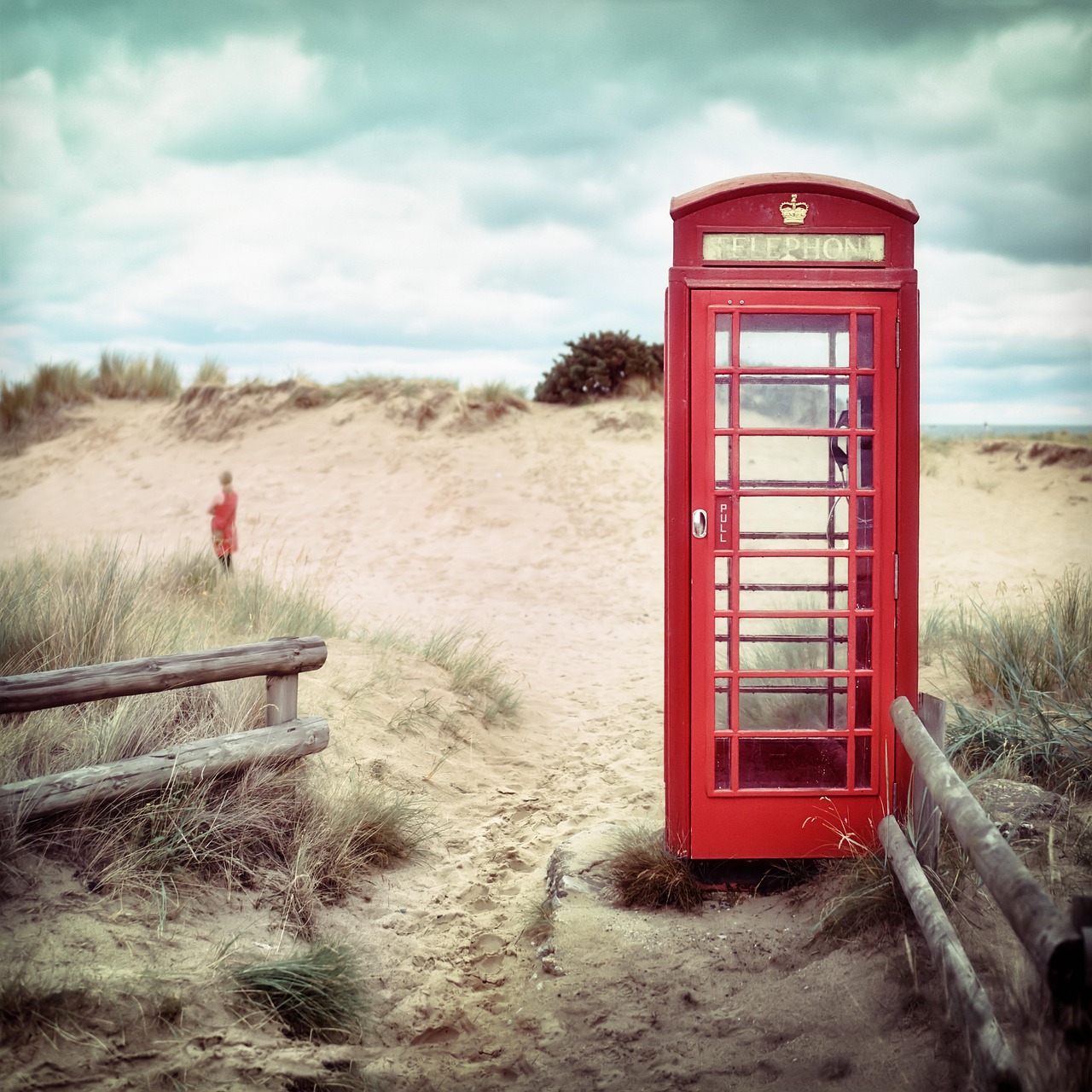An old phone booth on the beach.